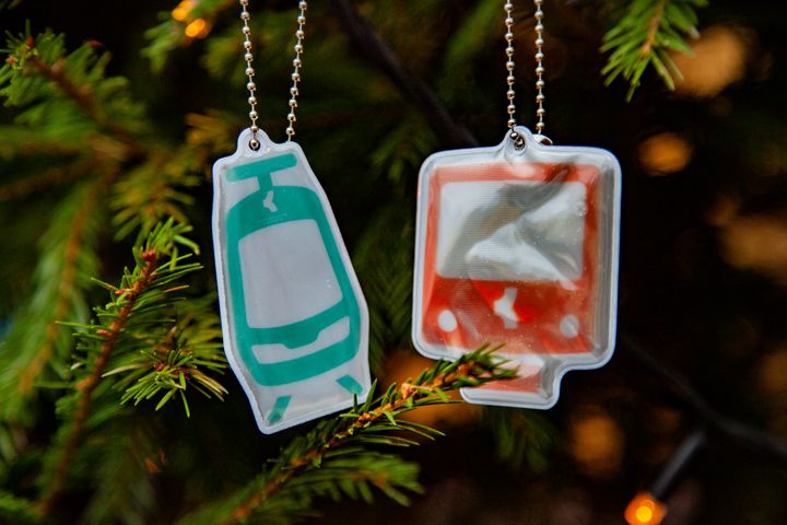 Pikaratikan ja metron muotoiset heijastimet roikkuvat kuusesta.