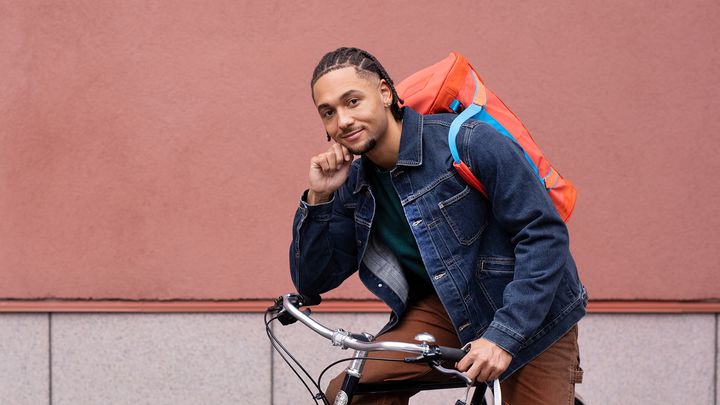 Young adult with a bicycle.