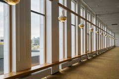 Light fittings in a row in front of big windows.