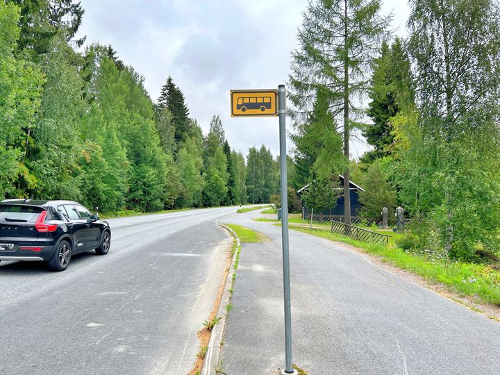 Bussipysäkki ja ohi ajava auto.