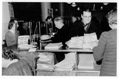 Valtiokonttori perustettiin 150 vuotta sitten, vuonna 1876, hoitamaan valtionrahastoja ja valtionvelan korkojen ja kuoletusten maksua. Kuvassa obligaatioiden lunastusta Valtiokonttorin salissa toisen maailmansodan jälkeen. Kuva: Valtiokonttori