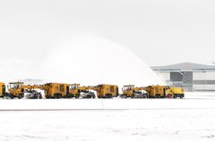 Runway maintenance with snow removal machines.