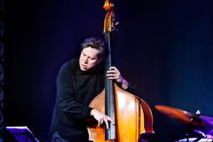 Bassist Antti Lötjönen performing on stage.