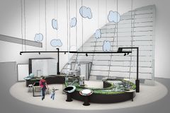 Näkymä modernista näyttelytilasta, jossa on kaareva interaktiivinen pöytä ja pyöreitä valaisimia katossa.