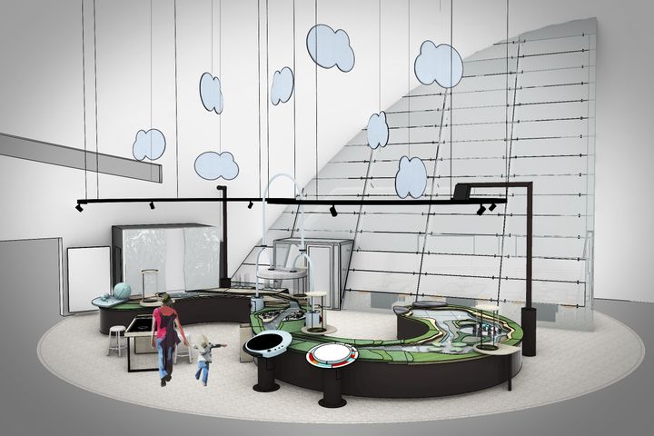 Näkymä modernista näyttelytilasta, jossa on kaareva interaktiivinen pöytä ja pyöreitä valaisimia katossa.