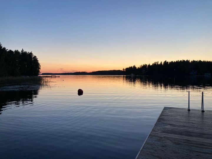 Syksyinen auringonlasku järvenrannalla.