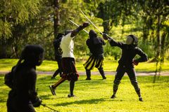 A group of historical fencers in the picture.