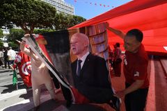 Backing for the President: Supporters of Tunisian President Kais Saied hold his image during a rally in Tunis, on July 25, 2024, as the nation celebrates the 67th anniversary of foundation of the republic. (Photo by Fethi Belaid / AFP)