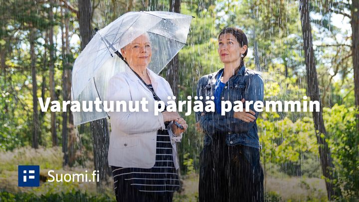 Kaksi naista vesisateessa. Toinen on varautunut sateenvarjolla, toinen ei. Varautunut pärjää paremmin.